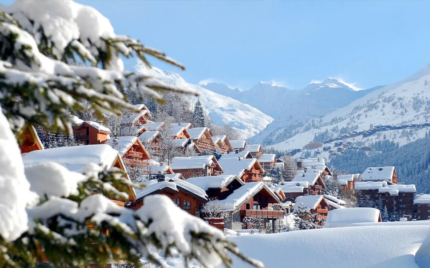 A row of Savoyard chalets in the Three Valleys at dusk